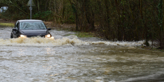 A car in a flooded road (stock image)